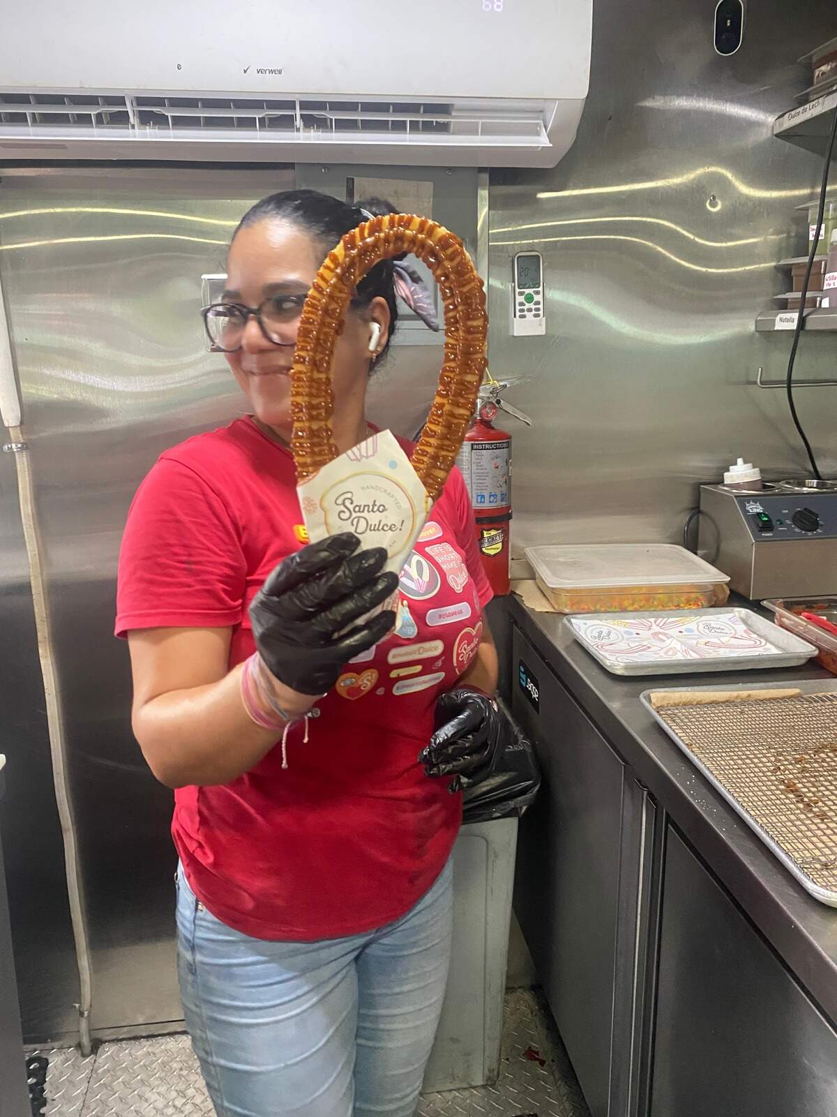 Betsa Velásquez with one of the halo-shaped churros that inspired the name of the churro business Santo Dulce! (Holy Sweet!), which aims to reinvent the traditional churro with new shapes and flavors in the dough and sauces.